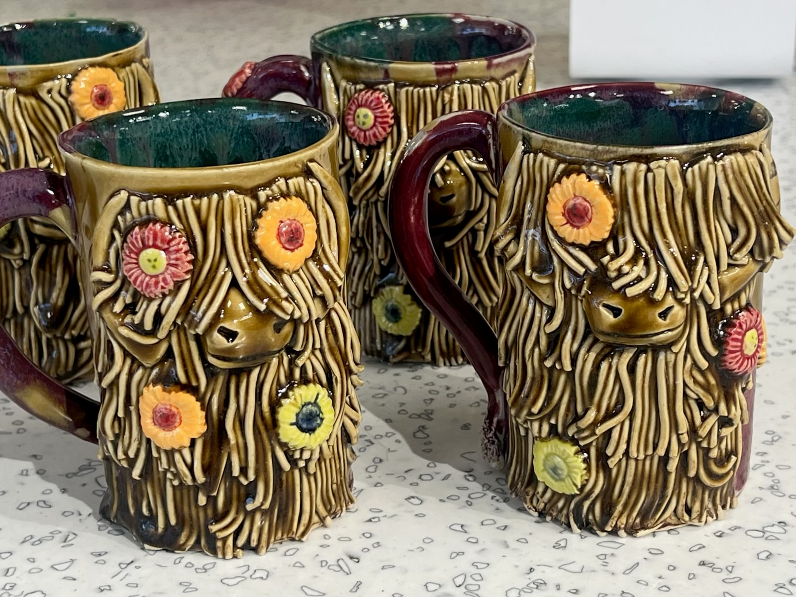 Wheel-thrown mugs and sculptures in progress at Alaska Mud Pottery studio in Juneau